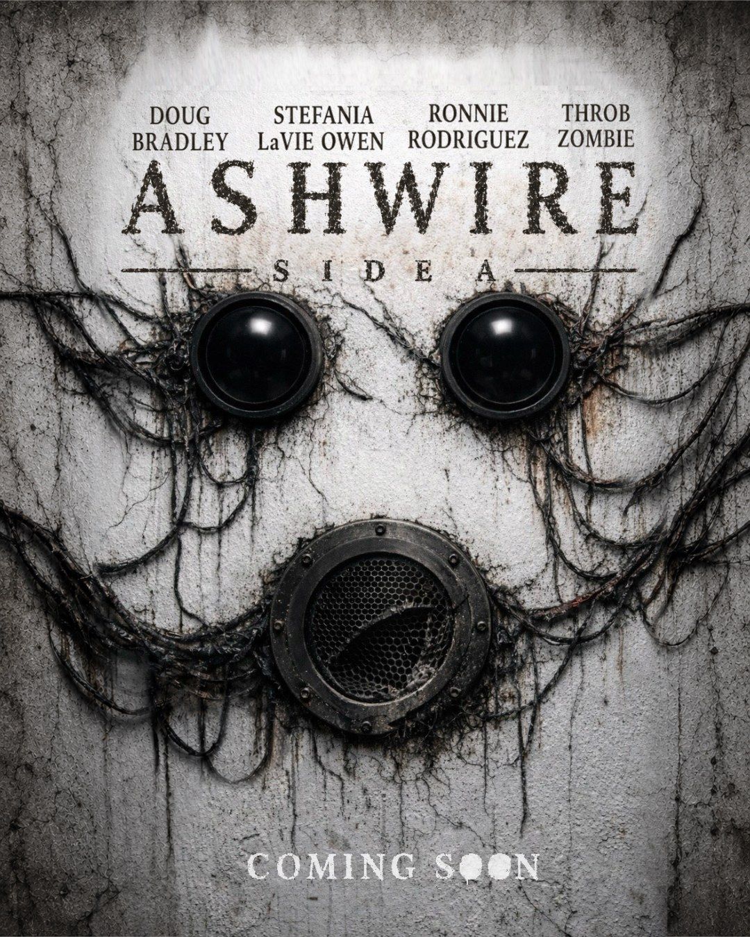 ASHWIRE poster: two black speaker eyes and a rusted grille mouth emerging from a cracked plaster wall, dead cables spreading like veins. Starring Doug Bradley, Stefania LaVie Owen, Ronnie Rodriguez, and Throb Zombie. Coming soon.